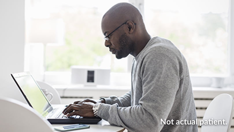 Man Researching on Laptop