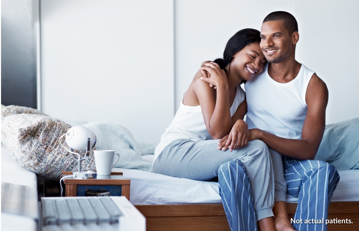 Couple Sitting on Bed
